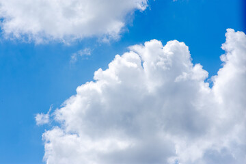white cumulus clouds in a blue sky. Panorama top of clouds and blue sky background