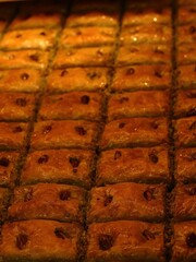 Rows of golden baklava, glistening with syrup and studded with pistachios, create a tempting display of this rich Middle Eastern dessert