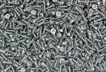 Six-Lobe Torx Flat Undercut Head machine screws many scattered fasteners.	