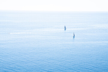 Two Sailing Boats on Calm Blue Sea Under Clear Sky