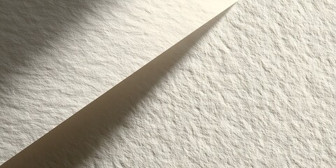 Abstract light and shadow on textured surface creating a diagonal split in the composition view