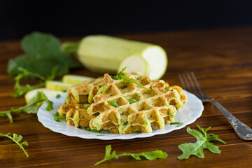 Vegetarian zucchini waffles served on a wooden table