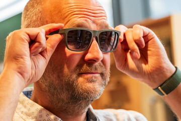 Happy man with bald head and sun glasses at shop 