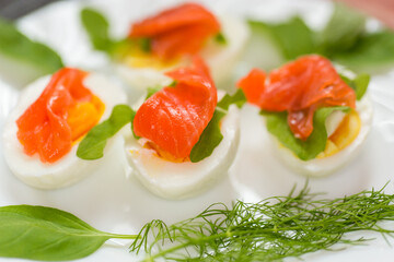 Egg whites and yolks with salmon for cold serving