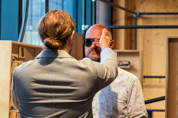 Happy man with bald head and sun glasses at shop 