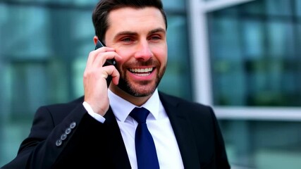Confident businessman engaging in a phone conversation outside a modern office building