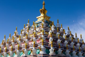 Colorful Vache Stupas at Zoigê Marsh in Amdo region, showcasing traditional Tibetan Buddhist architecture and sacred pilgrimage destination in Greater Tibet.