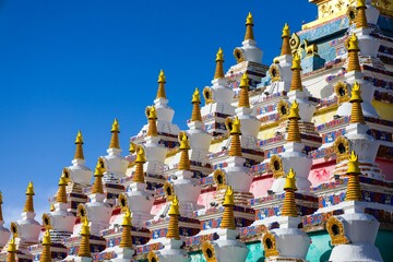 Colorful Vache Stupas at Zoigê Marsh in the Amdo region, showcasing traditional Tibetan Buddhist architecture and spiritual heritage in Greater Tibet.