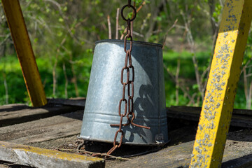 An old abandoned well stands quietly in the village, surrounded by overgrown grass and a sense of...
