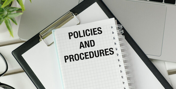 A notebook with the words policies and procedures written on it