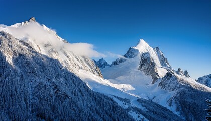 Obraz premium blue tinted mist over snow covered chamonix mountain ridge