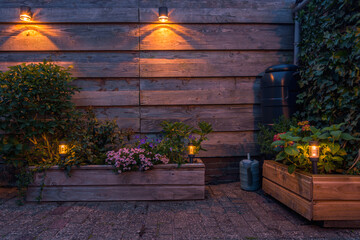 Solar-powered outdoor lighting illuminating a garden with flowers and plants. 