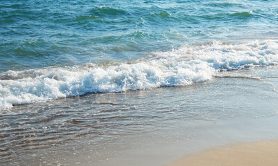 Soft wave of blue sea on sandy beach.