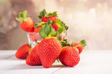 Jar with strawberries, a beautiful glass jar full of delicious strawberries on rustic wood, selective focus.