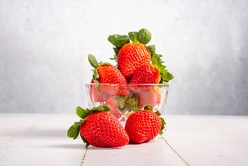 Jar with strawberries, a beautiful glass jar full of delicious strawberries on rustic wood, selective focus.