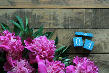 Pink peonies celebrating independence day on rustic wooden background