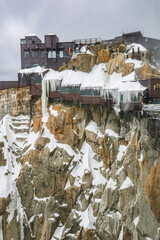 View of Aiguille du Midi mountain station in the Mont Blanc massif in the French Alps. Summit tourist station in foreground. Alps France Europe.	