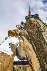 View of Aiguille du Midi mountain station in the Mont Blanc massif in the French Alps. Summit tourist station in foreground. Alps France Europe.	