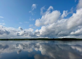 clouds reflected in water Kemijöki Finnland 