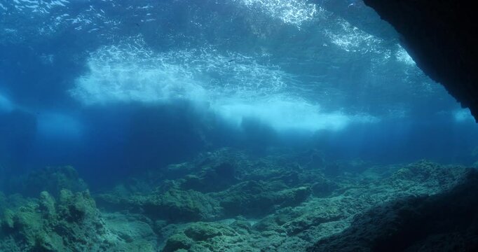 waves hiting rocks make foam underwater tough weather choppy ocean