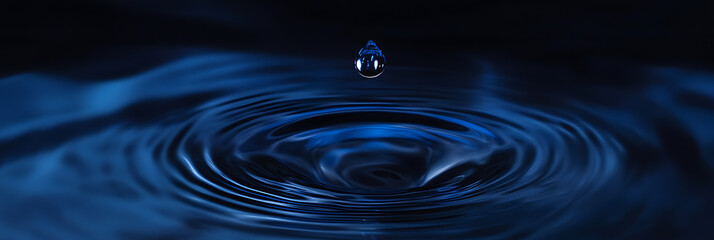 Water drop creating ripples, Water drop splash, blue ripple background, A falling water drop in dark and blue tone, Water splash crown and ripple effect