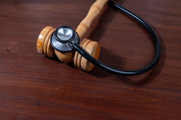 A powerful visual of a gavel and stethoscope placed together on a desk symbolizes the legal...
