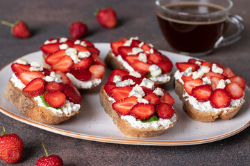 Bruschetta with strawberries, arugula and dor blue cheese for breakfast