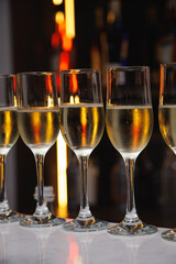 Glasses of champagne with bar lights in the background