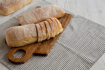 Homemade Ciabatta Bread on a wooden board, side view. Copy space.