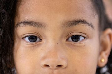 Close-up of young girl's eyes, expressing curiosity and wonder in school