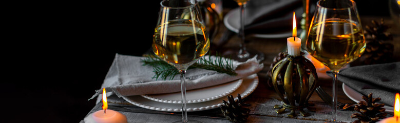 Banner. Rustic Scandinavian style zero waste eco-friendly dinner table decor for Christmas or new year family celebration. Wooden table, natural elements like pine cones, fir tree branches, candles