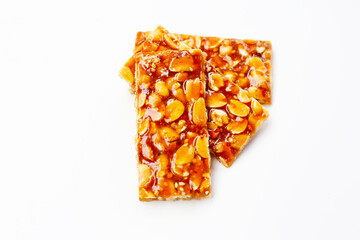 Crispy peanut brittle bars coated in glossy caramel.