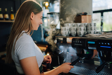 Smiling barista preparing coffee with professional espresso machine