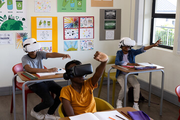 In school, diverse students using virtual reality headsets for interactive learning experience