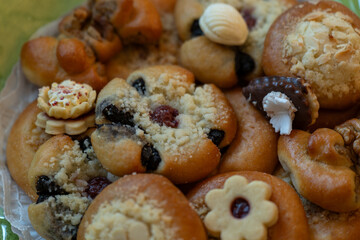 A detailed view of the top part of pastries and sweets side by side.
