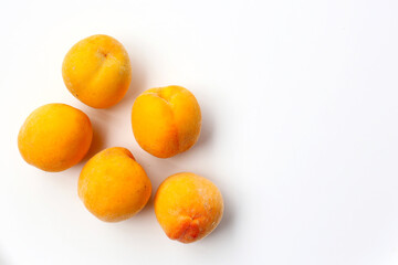 Fresh ripe apricots on a white background.