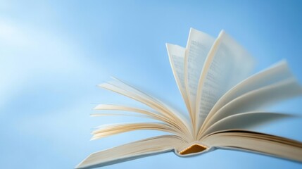 Open book against a light blue sky