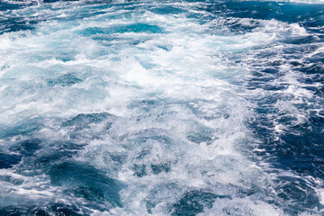 Ocean water background with foam. Ocean water splash. Not a calm