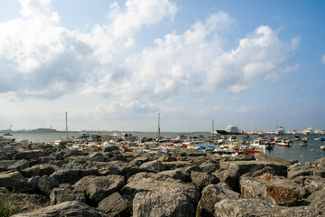 Bustling Kartal Marina in Istanbul Turkey with Colorful Fishing Boats, Luxury Yachts and Sailboats Moored in Sunny Mediterranean Harbor with Rocky Coastline