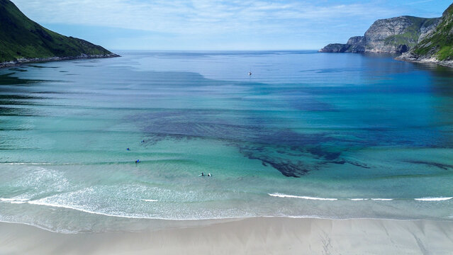 Surfers Waiting in Clear Blue Water, Hoddevik