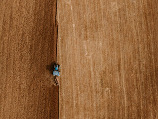 Top view of a tractor plowing a field