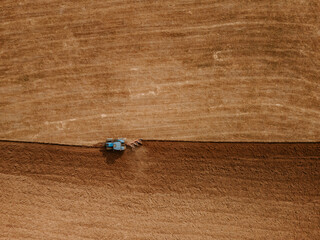 Top view of a tractor plowing a field