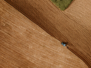 Top view of a tractor plowing a field