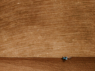 Top view of a tractor plowing a field