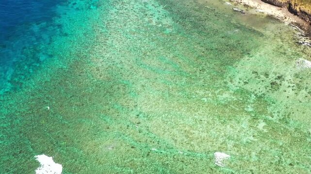 Vertical aerial panorama of coral reefs at Hideaway beach on Tokoriki island in Fiji.
