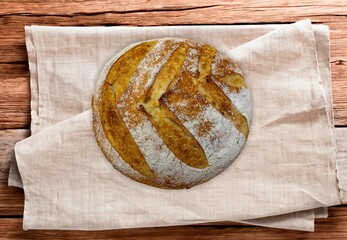 Freshly baked artisan sourdough bread on a wooden board.
