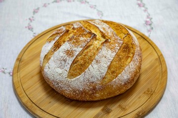 Freshly baked artisan sourdough bread on a wooden board.