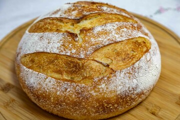 Freshly baked artisan sourdough bread on a wooden board.