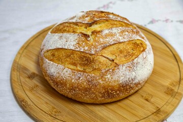 Freshly baked artisan sourdough bread on a wooden board.