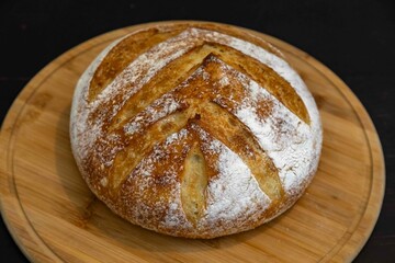 Freshly baked artisan sourdough bread on a wooden board.
